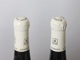 three bottles of wine that are sitting on a table