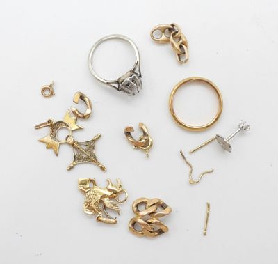 a group of various rings and earrings on a white surface