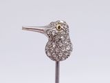a close up of a bird shaped object on a metal stick