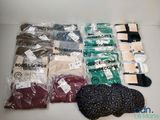 many different types of clothing in the bag on the table