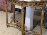 a marble top table in the middle of a tiled floor