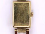 an image of a close up of a wrist watch on a white surface
