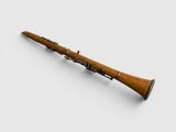 a close up of a wooden clarinet on a white surface