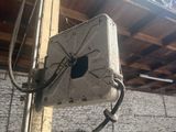 a white box that is attached to the side of a building