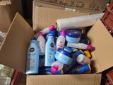 a cardboard box full of baby care products on the floor