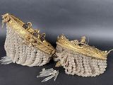 a pair of gold and crystal beaded purses with tassels