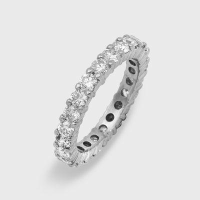 a close up of a diamond eternity ring on a white background