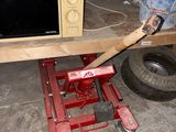 a microwave sitting on top of a dolly in a garage