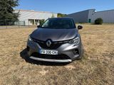 the front of a grey car parked in a field