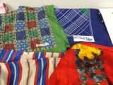 many different types of clothing displayed on a table