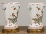 two vases that are sitting on a table