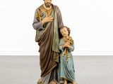 the statue of jesus and a child is standing on a pedestal