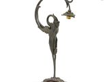 an image of a bronze statue of a woman holding a lamp