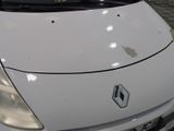 a small white car parked on the side of the street