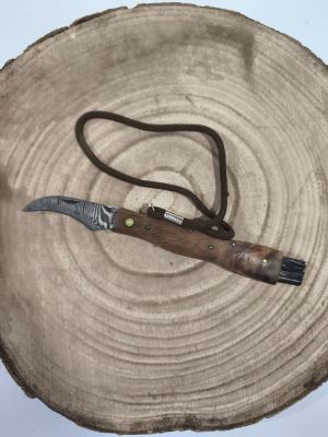 a knife that is laying on top of a piece of wood