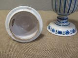 pair of blue and white vases sitting on top of a table