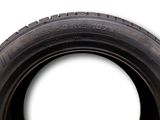 an image of a tire on a white background with a sticker on it