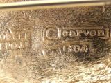 a close up of a silver plate on a table