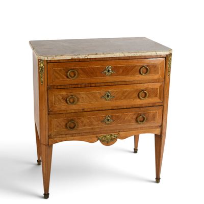 an antique chest of drawers with marble top and brass handles