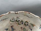 a bowl with a painting on it sitting on a table