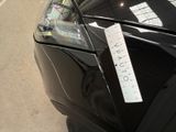 a car with a price tag on it parked on the side of the road