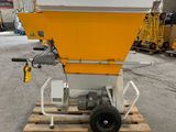 a yellow and white machine sitting on top of a wooden pallet
