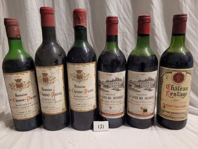 several bottles of wine are lined up on a table