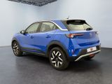 the rear view of a blue car in a showroom