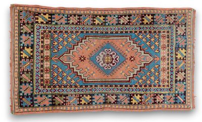 a blue and orange rug with a medallion design