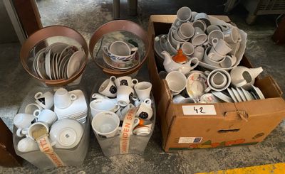 many cups and saucers in a box on the floor