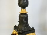 a black and gold vase sitting on top of a table