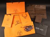 louis vuitton bags and a pair of sunglasses sitting on a table