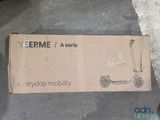 a cardboard box on the ground with a scooter on it