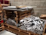 a pile of metal and wooden pallets in a warehouse