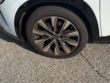a picture of a white car parked in a parking lot