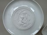 a white plate with a picture of a woman on it