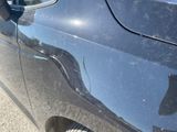 a close up of a car ' s door handle with a hole in it