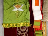 several pieces of cloth and a pair of scissors on the table