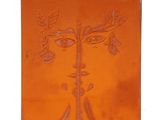 an orange tile with a picture of a tree on it