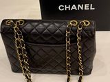 a chanel black quilted bag with gold chain