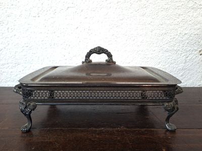 a silver plate with a handle on a wooden table