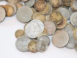 a pile of coins sitting on a white surface