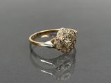 a close up of a gold and diamond ring on a black surface