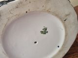 a close up of a white and black plate on a table