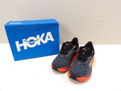 a pair of shoes sitting on a table next to a box