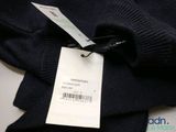 an image of a black sweater with a price tag on it