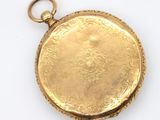 an image of a close up of a gold pocket watch on a white surface