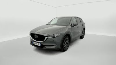 a grey mazda cx - 5 parked in a white room