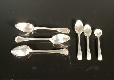 five spoons and two spoons sitting on a table