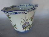 a blue and white bowl with a flower design on it